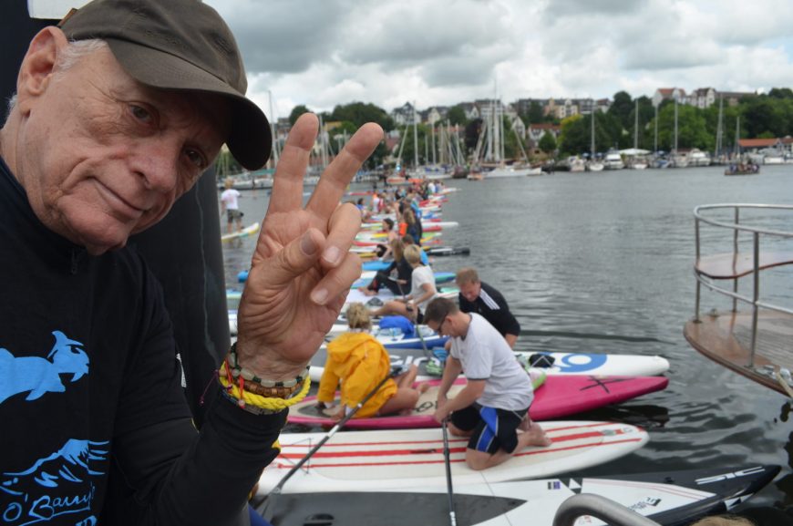 Ric O'Barry successfully crosses Flensburg harbor via 200 standup paddle boards to bring awareness to Taiji dolphin slaughter